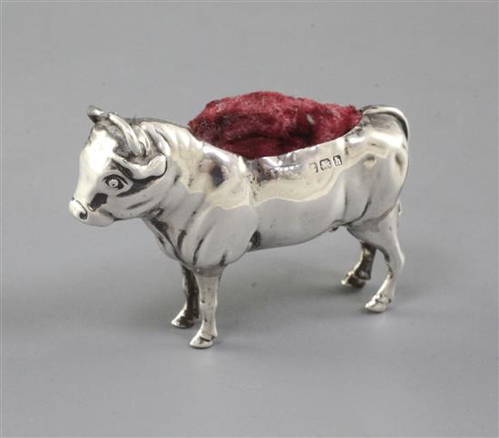 An Edwardian novelty silver pin cushion modelled as a bull by Adie & Lovekin, 2.25in.